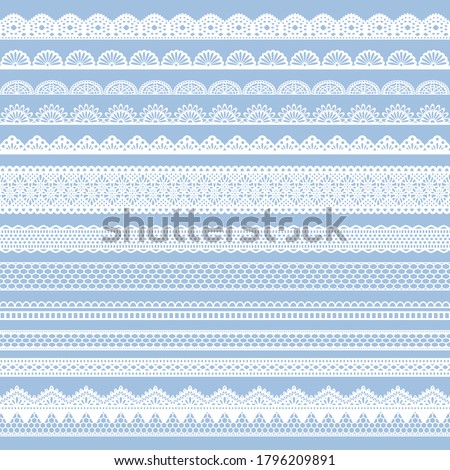 
Set of seamless white lace ribbons on blue background.