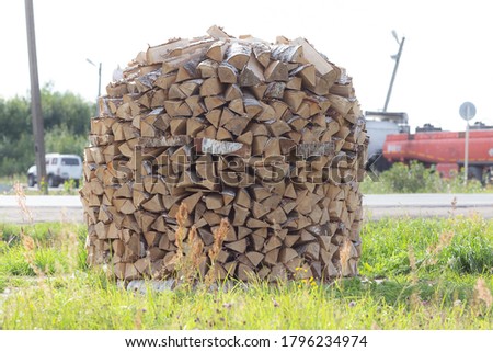Chipped birch firewood. The firewood is neatly stacked.