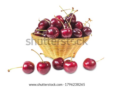 Clipping path. Cherries in wood basket isolate on white background