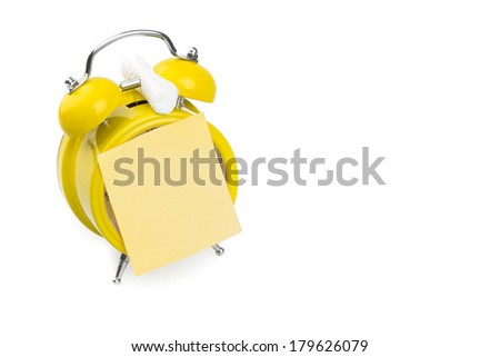 Yellow alarm clock with a cheerful note. on a white background