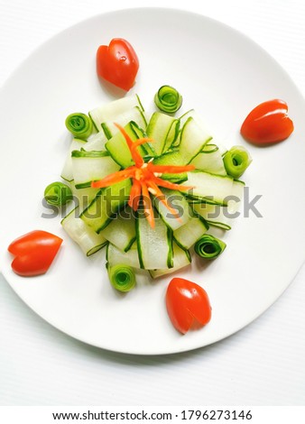 Food decoration with cucumbers and tomatoes Or setting up dishes with vegetables