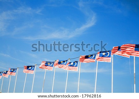 row of Malaysian flags waving outdoor in the field