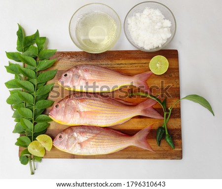  pink Perch fish with ingredients like lemon,curry leaves,chilli ,also known as kili meen .selective focus. Royalty-Free Stock Photo #1796310643