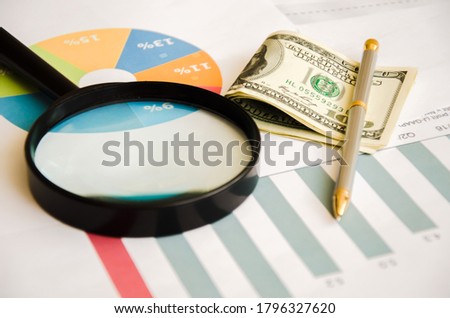 Magnifier calculator lies on a color chart. financial responsibility. High quality photo