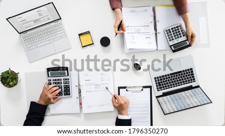 Auditors Calculating Corporate Invoicing And Tax Budget Royalty-Free Stock Photo #1796350270