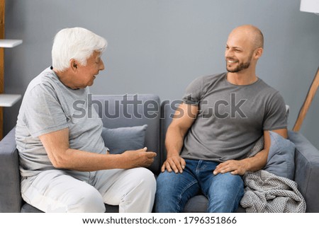 Grandpa Talking To His Grandson In Living Room