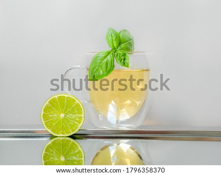 Refreshment concept with a glass cup of lemon and lime tea