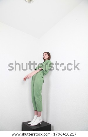 Beautiful young girl in a business suit in light green color. Catalog shooting. Fashion shooting. Business clothes.
