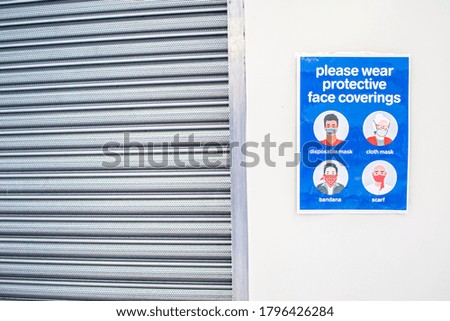 Please wear protective face coverings poster