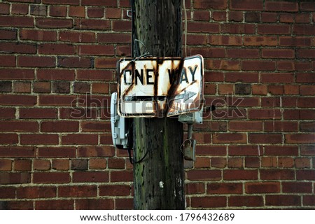 One way street sign in alley