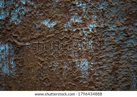 Still-life. Photo of the wall surface with streaks and clumps of plaster. In Dark Reds and bright Blues.