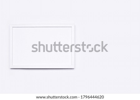 White wooden frame with empty space for text. Everything is arranged on a white background. Flat top view.