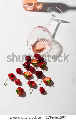 Concept composition presenting rose wine flavours of summer fruits of berries on white background Royalty-Free Stock Photo #1796461597