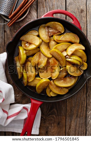 Fried apples with cinnamon in a cast iron skillet, fall side dish