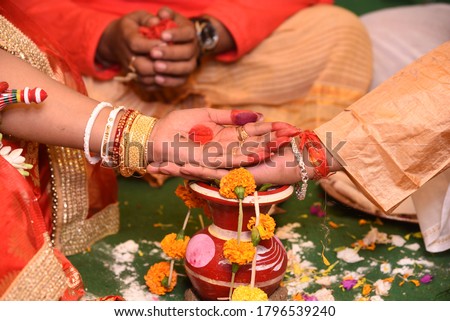Groom and bride's palm kept on each other during hindi bengali marriage rituals.
