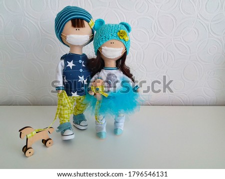 Handmade dolls with a medical mask on their face.Texture or background