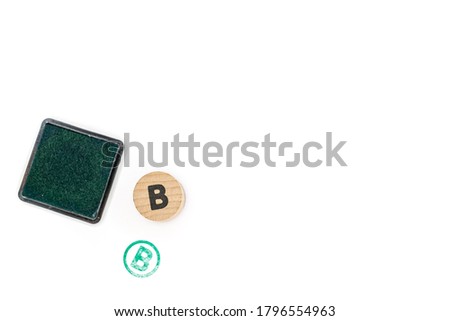 round wooden stamp letter B stamped and pad with green ink