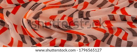 Texture. Background. Template. Beige silk fabric with red and black geometric rhombus shapes.