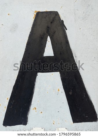 letters written on the wall in black paint 
