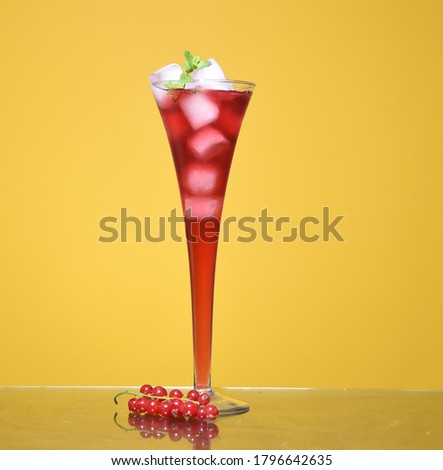 Glass with drink on yellow background