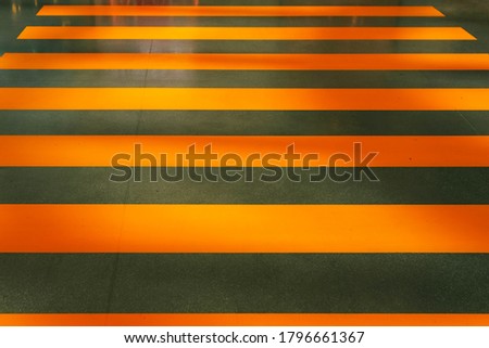 abstract background of an orange pedestrian crosswalk