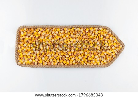 Pointer made of rope, filled with a grain of corn. Isolated on white background