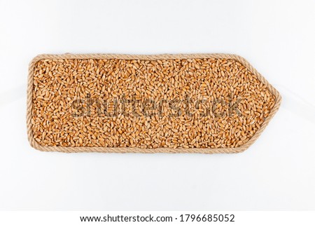 Pointer made of rope, filled with a grain of wheat. Isolated on white background