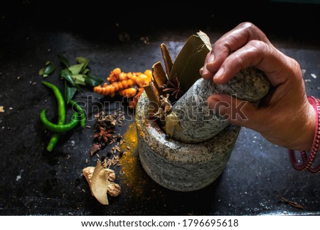 Picture of a masala pot where tasty and healthy spices are being crushed. The ancient Indian method to crush the spices.