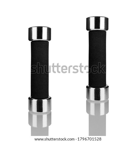 Two dumbbells on white background with reflection isolated closeup, metal barbells with black arm set, pair of fitness bar-bells, sport equipment, bodybuilding concept, healthy lifestyle, gym training