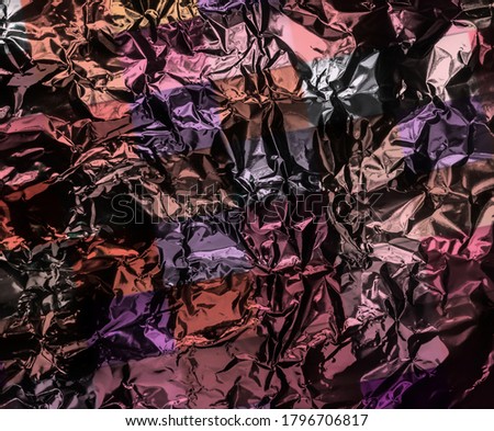 Abstract texture pattern metallic paper using as a background or wallpaper. Metal aluminum foil shiny and reflector