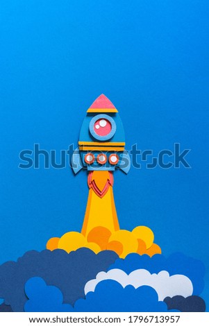 Rocket takes off paper craft. Back to school. Copy space. Blue background. Business concept