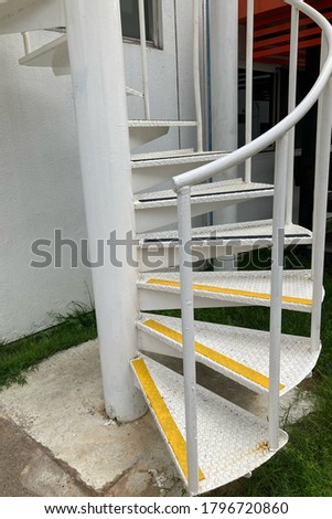 Industrial factory spiral staircase mounted outside the building