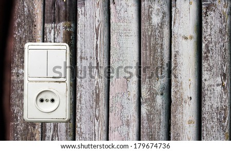 outlet and switch on the background of wooden wall