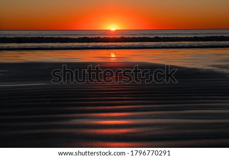 Image of a beautiful sunset on Cable Beach in Broome, Western Australia. Broome is a popular holiday destination in Australian winter. 
