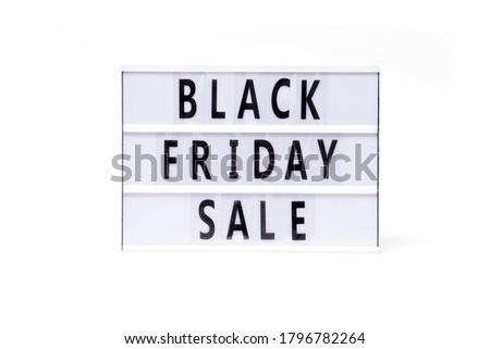 Black friday sale. Text on a vintage lightbox display placed on a white table on a light background.                       