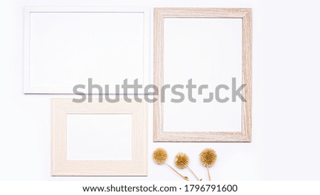 Summer composition. Three wooden frames with empty space for text. There is dried grass at the bottom. Everything is arranged on a white background. Flat top view.
