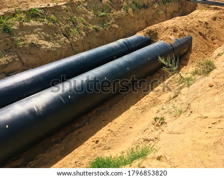 new insulated water pipes in the trench construction site . urban sewerage infrastructure