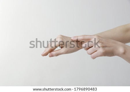 Close up of woman finger touching hand