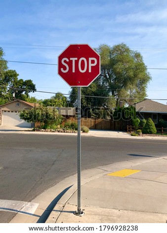 A stop sign next to a city street