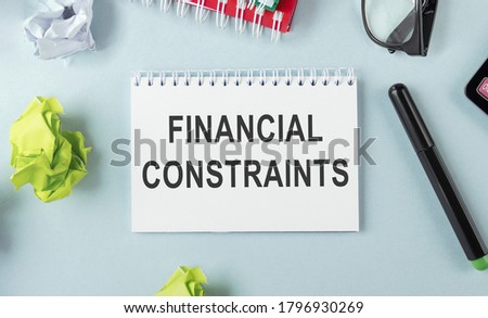 card with text FINANCIAL CONSTRAINTS, business concept image with soft focus background Royalty-Free Stock Photo #1796930269
