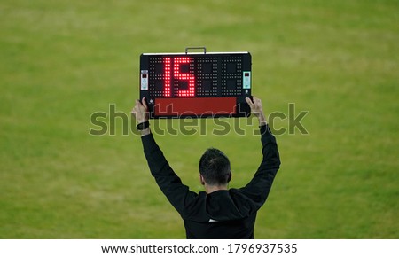 Football referee shows the number display announcing the change of players during the soccer match