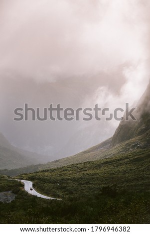 
The road to Milford Sound among majestic mountains, Foggy landscape