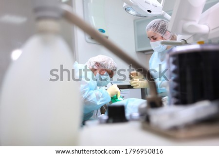 Dentists perform an operation to remove caries in a small child. Operation under General anesthesia. The device of artificial ventilation of lungs. Photo in the operating room. Copy space.