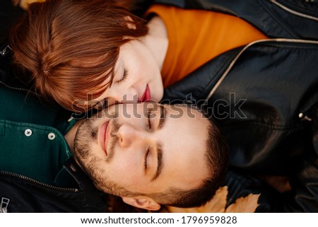 close up. portrait of a man and woman lying on autumn leaves in the Park.