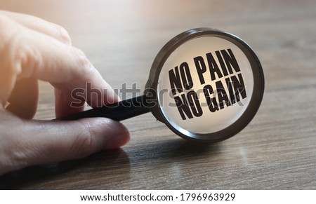 No Pain No Gain text concept with magnifying glass