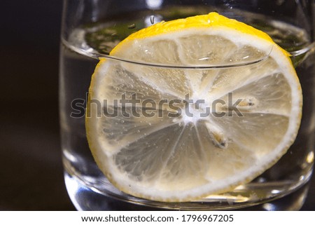 Summer drink with lemon mint leaves on a black background