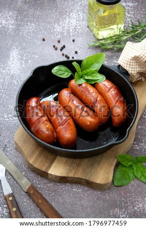 Cooked sausages on a frying skilette pan, meat sausages, breakfast