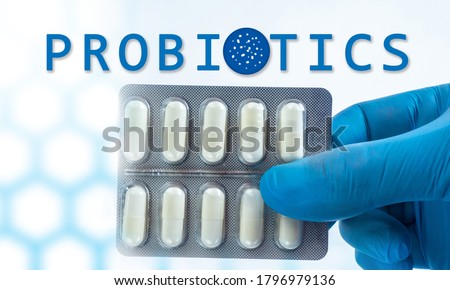 Probiotic bacteria. Blister with pills in doctor's hand. Probiotics logo next to pills. Concept - doctor recommends use of probiotic bacteria. Pro biotic. Immunity Support with Probiotic Bacteria.