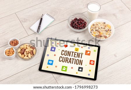 Healthy Tablet Pc compostion with CONTENT CURATION inscription, Social networking concept