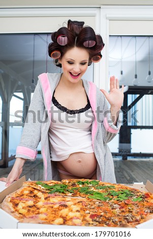 Pregnant woman eating pizza